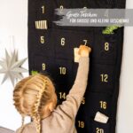 Papierdrachen Adventskalender 2026 – Bestickter Wandteppich Schwarz-Gold 120x60 cm – Bild 5